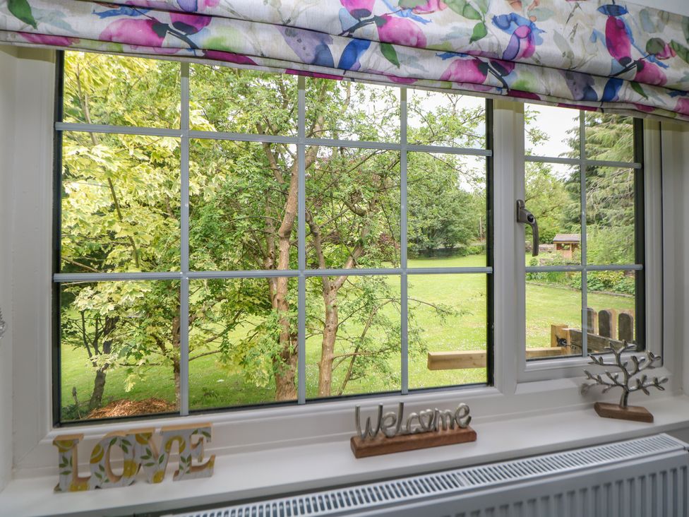A view from a window with trees and decorative items at Stoney Rock Lodge