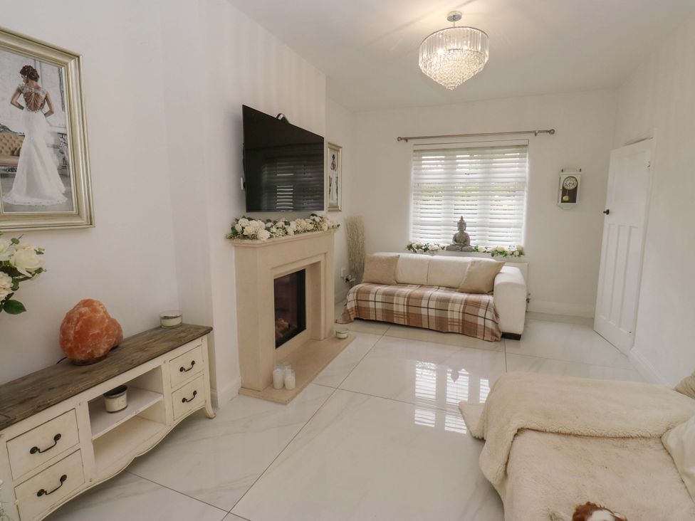 A living room with a sofa and television at St Mary's House in Oldham
