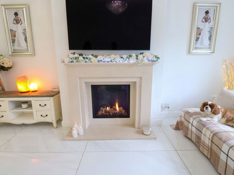 A living room with a fireplace and a television at St Mary's House in Oldham