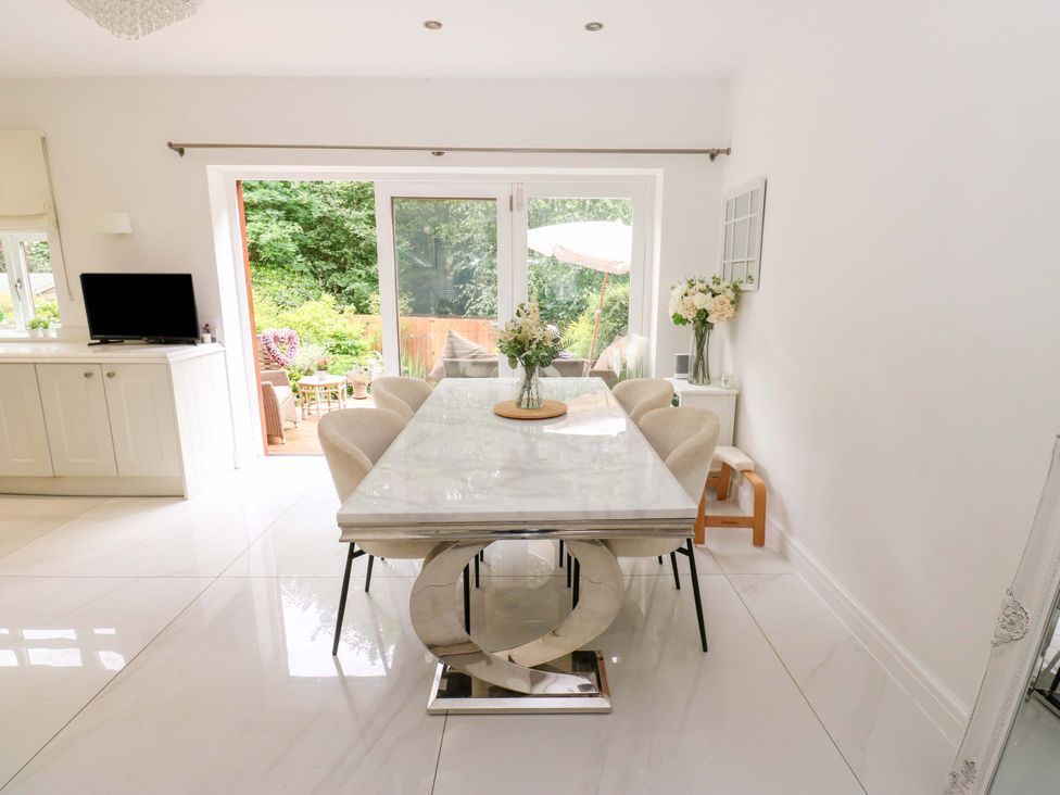 A dining room with a table and chairs at St Mary's House in Oldham