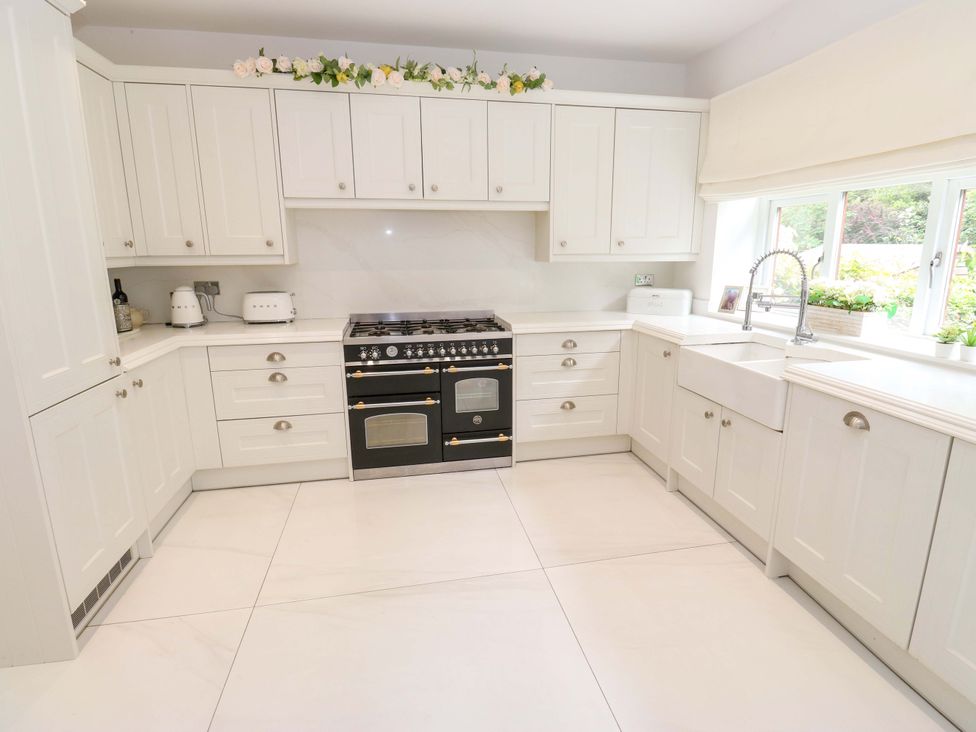 A kitchen with cabinets and a stove at St Mary's House Oldham