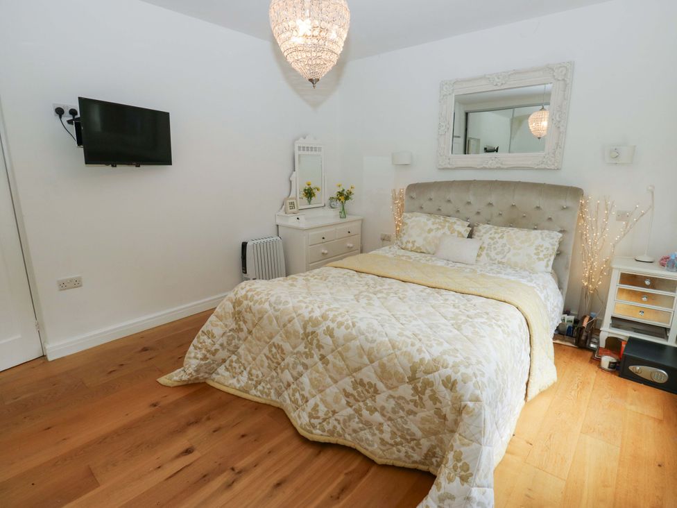 A bedroom with a bed and television at St Mary's House in Oldham