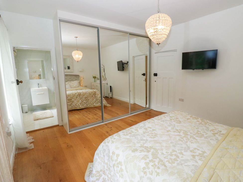 A bedroom with a bed and wardrobe at St Mary's House in Oldham