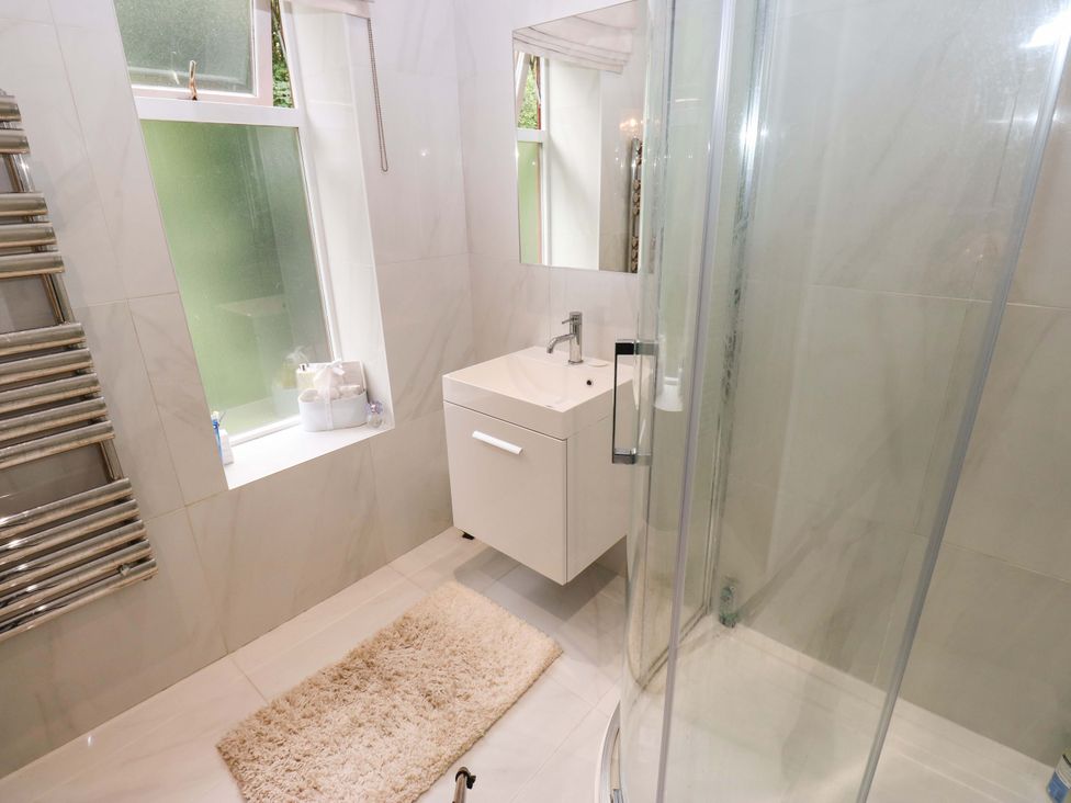 A bathroom with a shower and sink at St Mary's House in Oldham