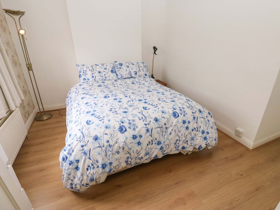 A bedroom with a bed and lamp at St Mary's House in Oldham
