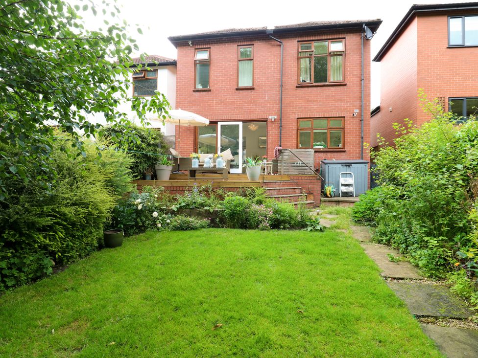 A garden with a house in the background at St Mary's House in Oldham