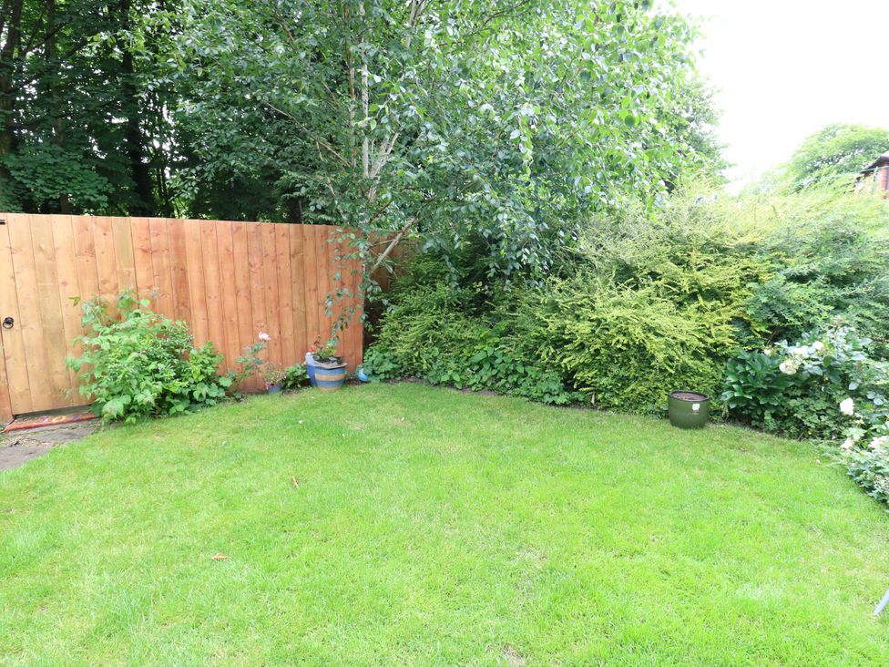 A garden with grass and plants at St Mary's House in Oldham
