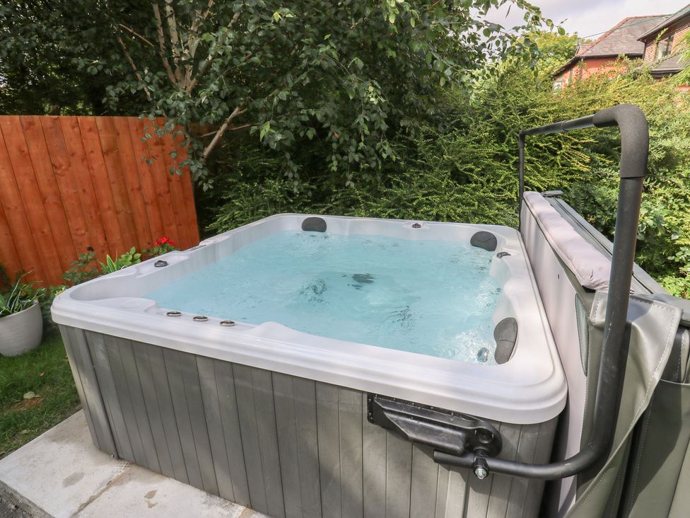 A hot tub in a garden at St Mary's House in Greenfield