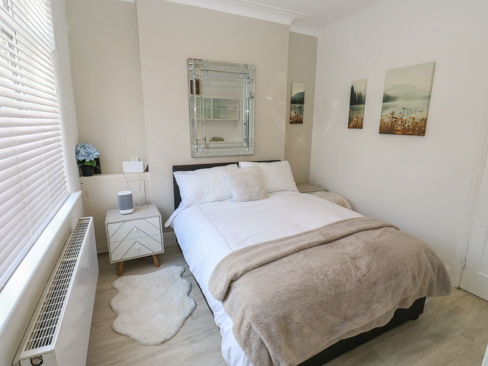 A bedroom with a bed and nightstand at St Mary's House in Greenfield
