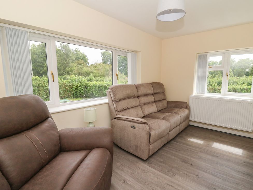 A living room with a sofa and armchair at Glandwr House Llandrindod Wells