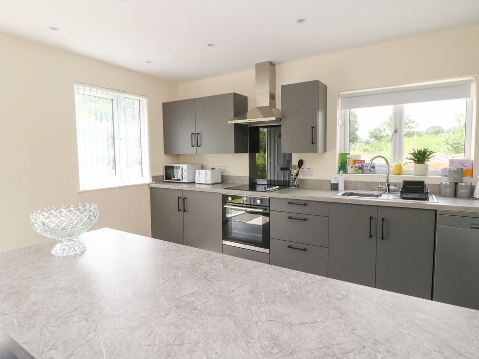A kitchen with cabinets and appliances at Glandwr House Llandrindod Wells