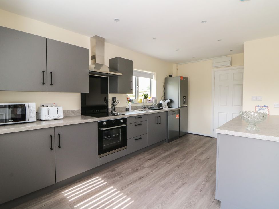 A kitchen with appliances and worktops at Glandwr House in Llandrindod Wells