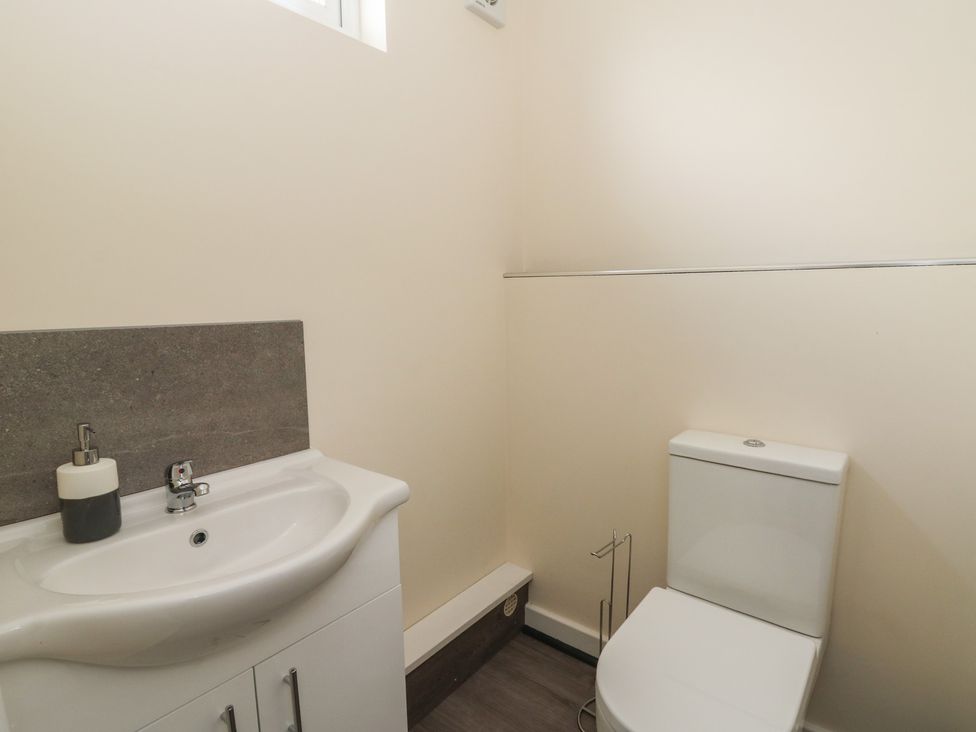 A bathroom with a sink and toilet at Glandwr House Llandrindod Wells