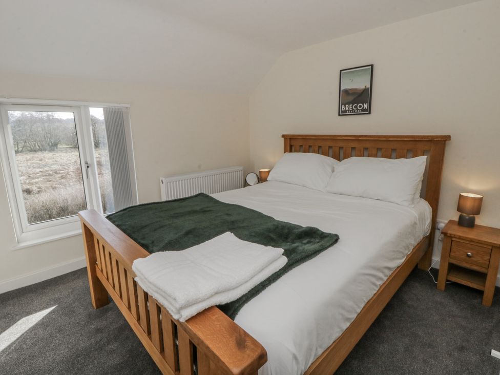 A bedroom with a double bed and bedside tables at Glandwr House Crossgates near Llandrindod Wells