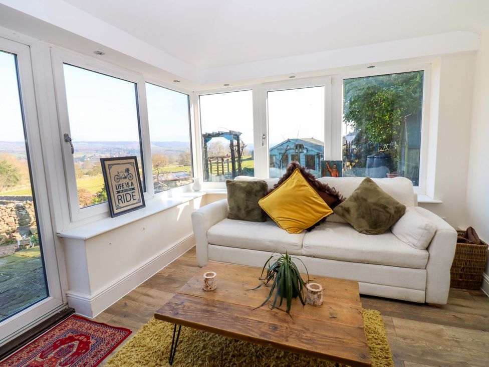 A snug with a sofa and coffee table at Eastend Cottage