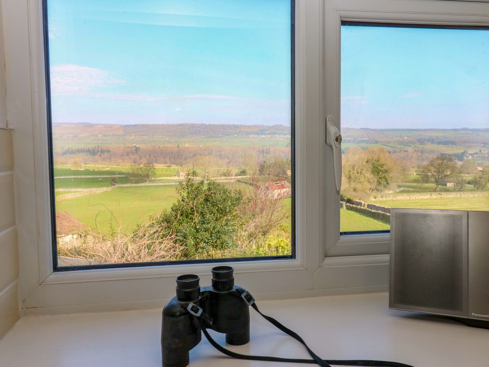 A window with binoculars and a speaker at Eastend Cottage