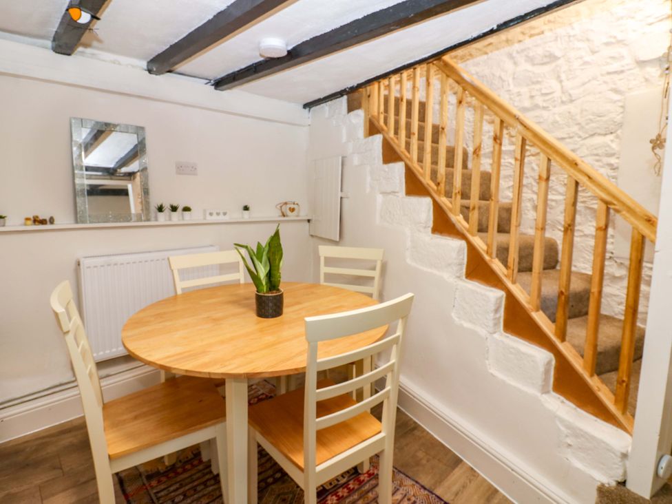 A dining room with a table and chairs at Eastend Cottage