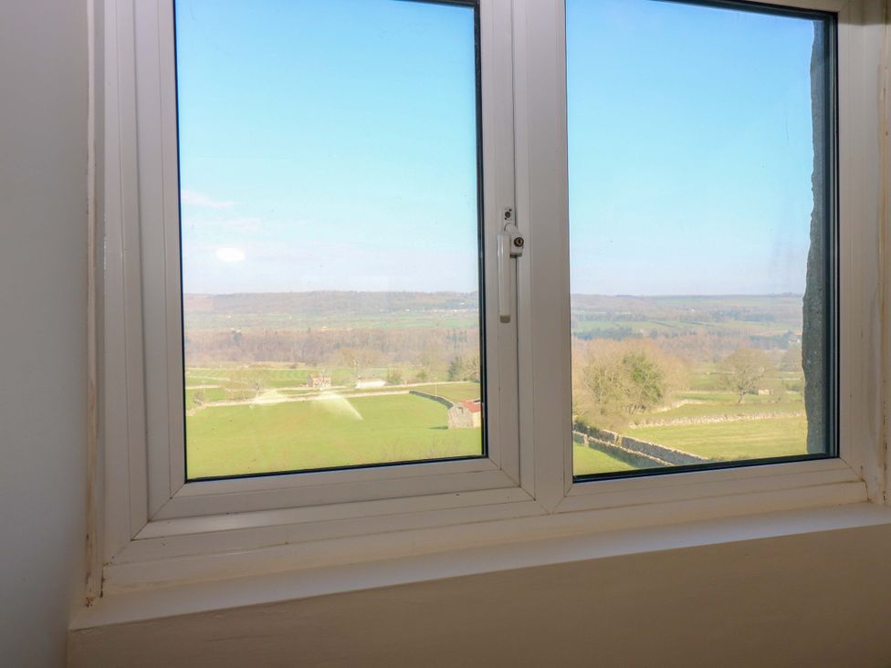 A window showing a landscape view at Eastend Cottage