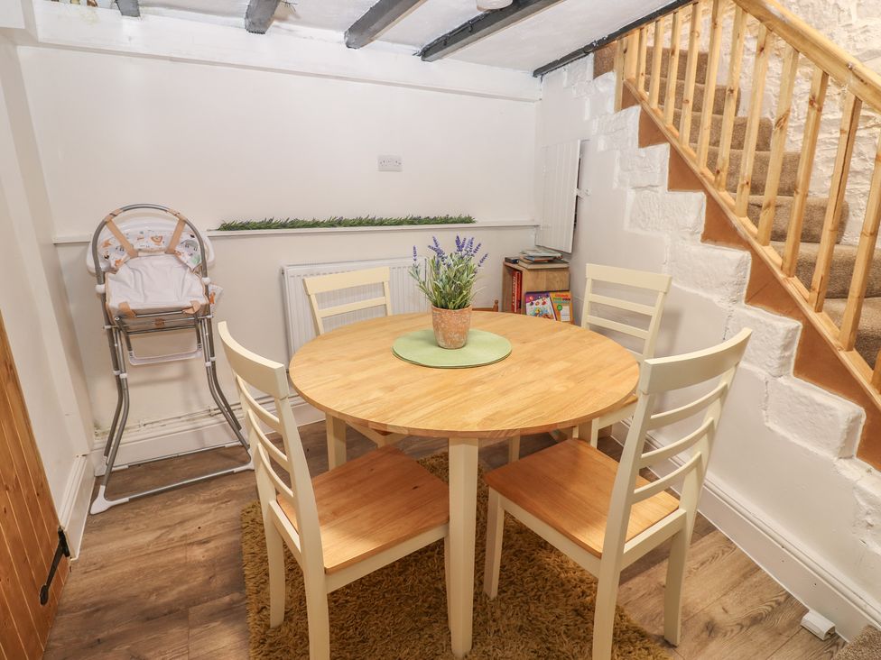 A dining room with a table and chairs at Eastend Cottage in West Witton