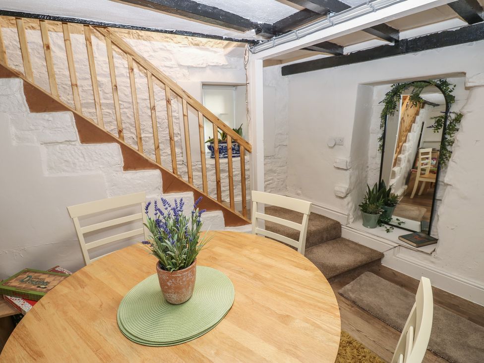 A dining room with a table and chairs at Eastend Cottage in West Witton