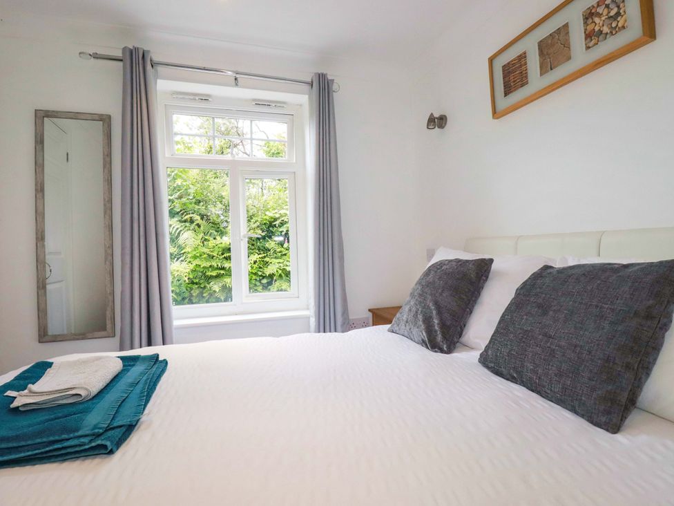 A bedroom with a bed and window at Sea Thrift White Cross near Indian Queens