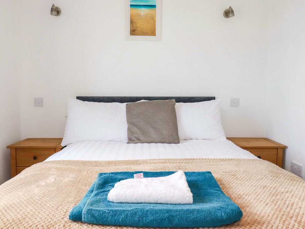 A bedroom with a bed and pillows at Sea Thrift White Cross near Indian Queens