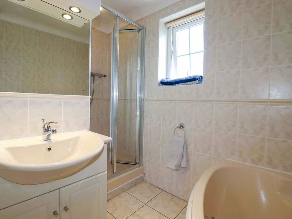A bathroom with a sink, shower and bath at Sea Thrift, White Cross near Indian Queens