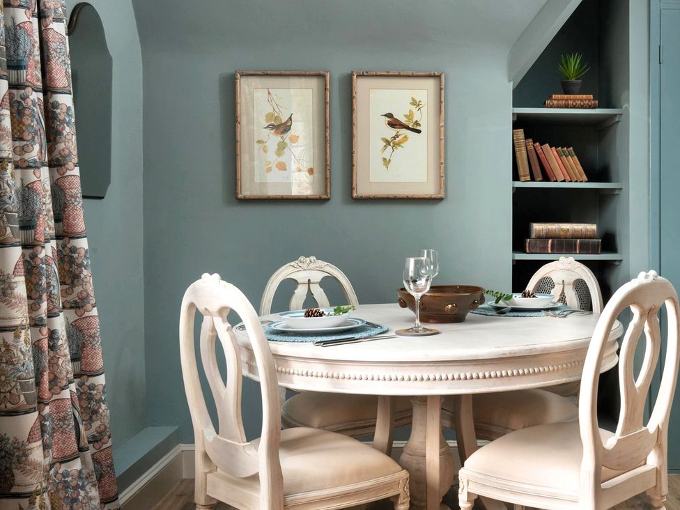 A dining room with a table and chairs at Whistler Rooms