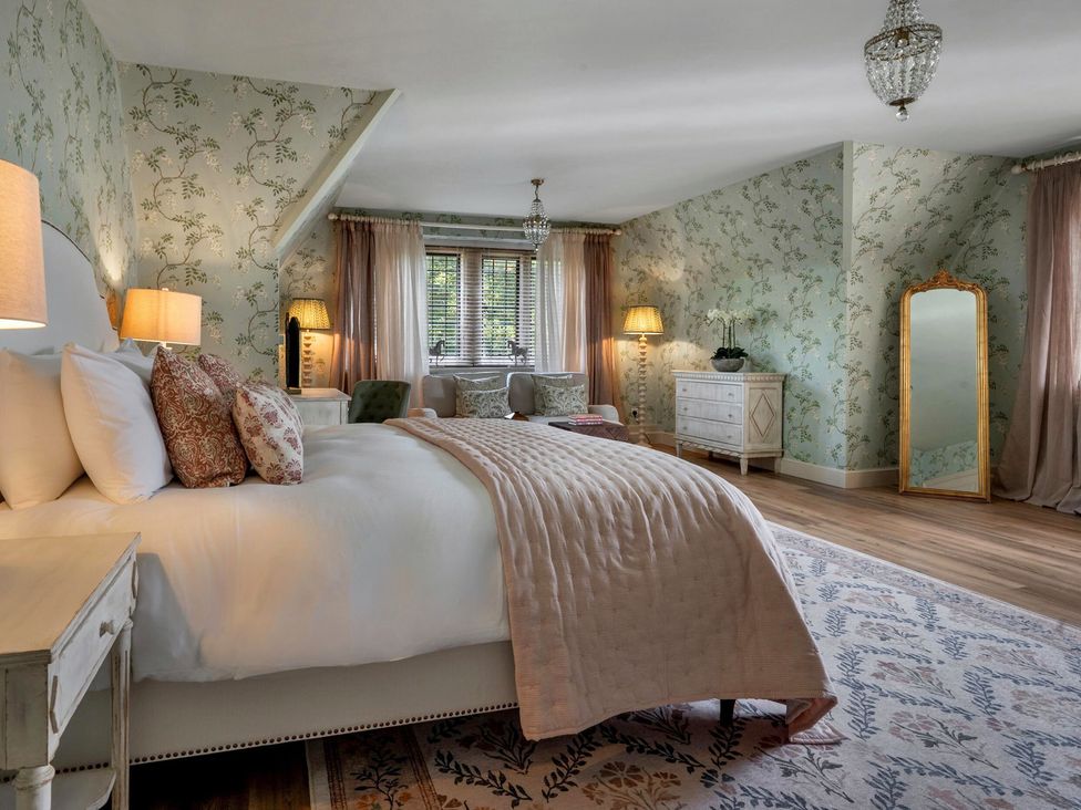 A bedroom with a bed and nightstand at Whistler Rooms