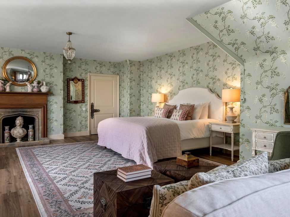 A bedroom with a bed and fireplace at Whistler Rooms