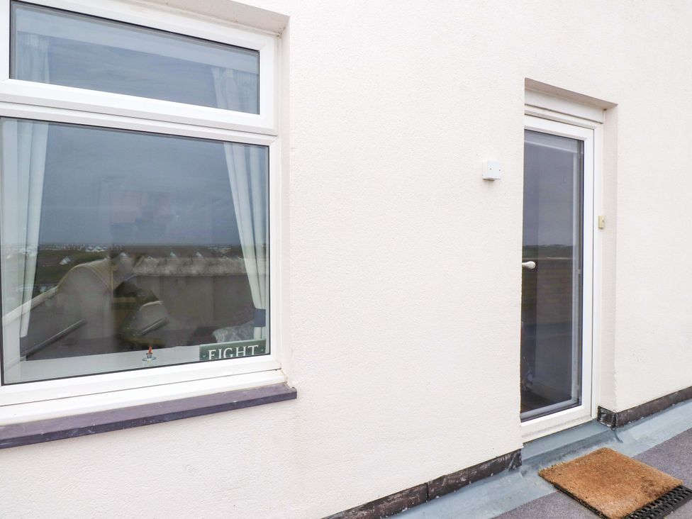 An outdoor area with a window and door at Sea Views No 8 Plas Darien in Trearddur Bay