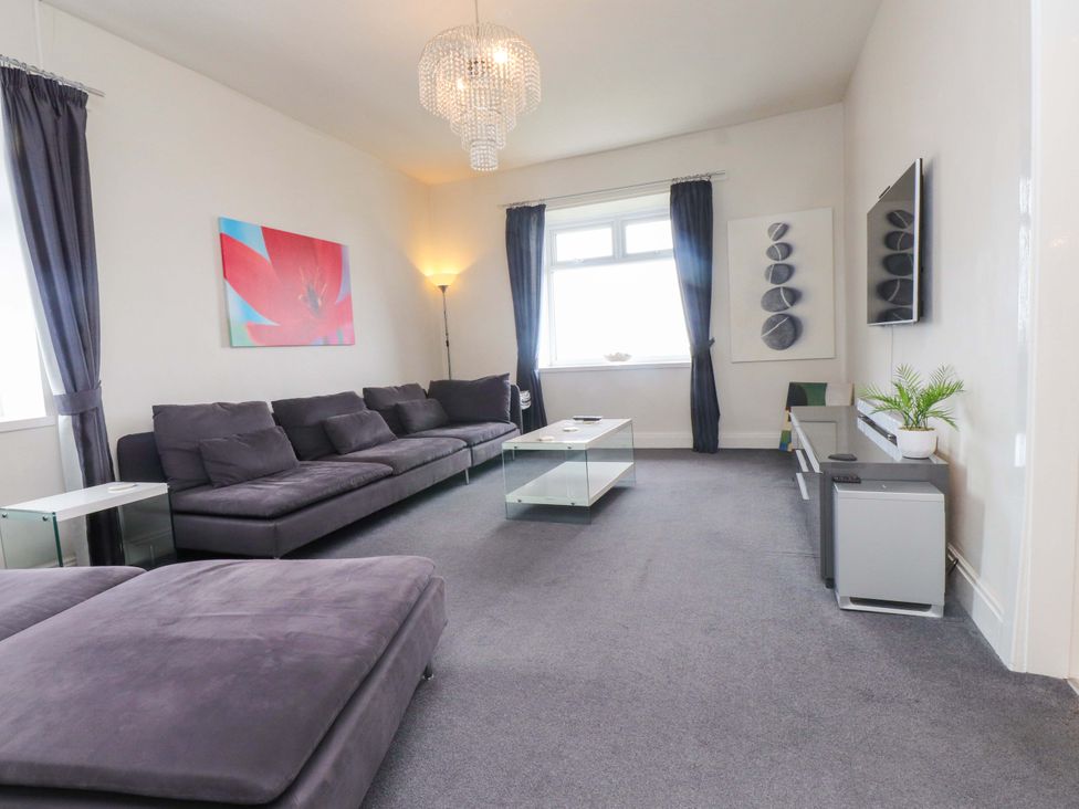 A living room with a sofa and coffee table at Sea Views No 8 Plas Darien, Trearddur Bay
