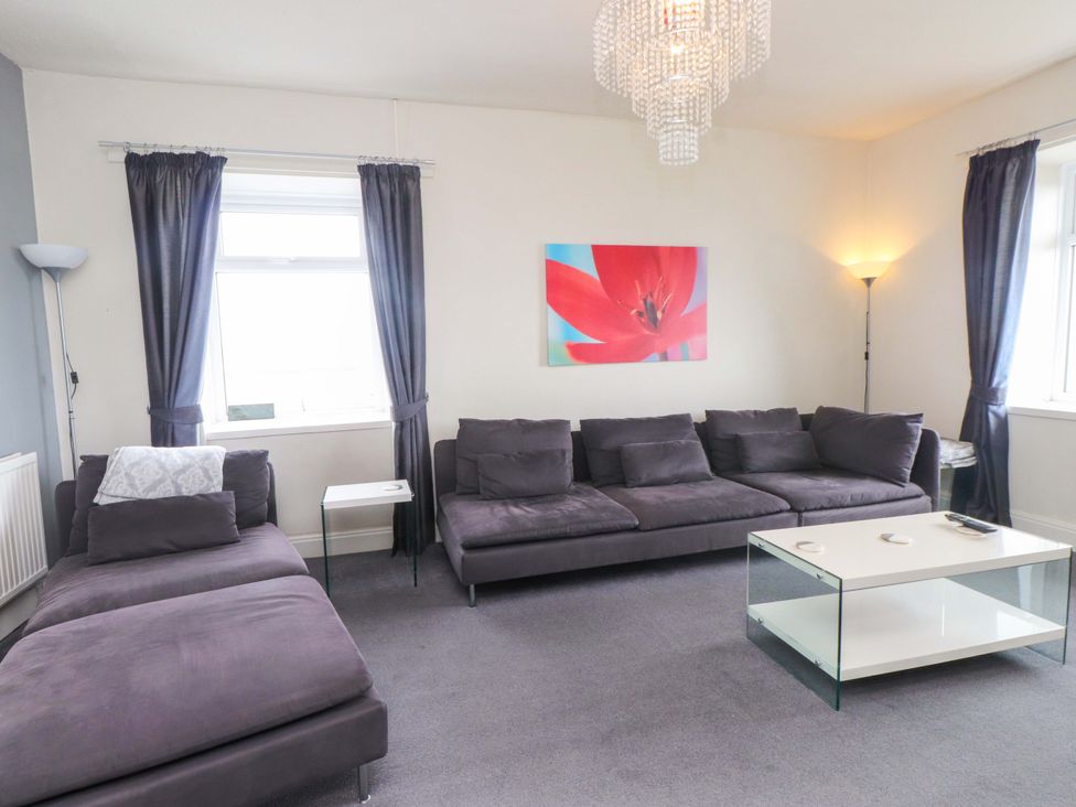 A living room with a sofa and coffee table at Sea Views No 8 Plas Darien, Trearddur Bay