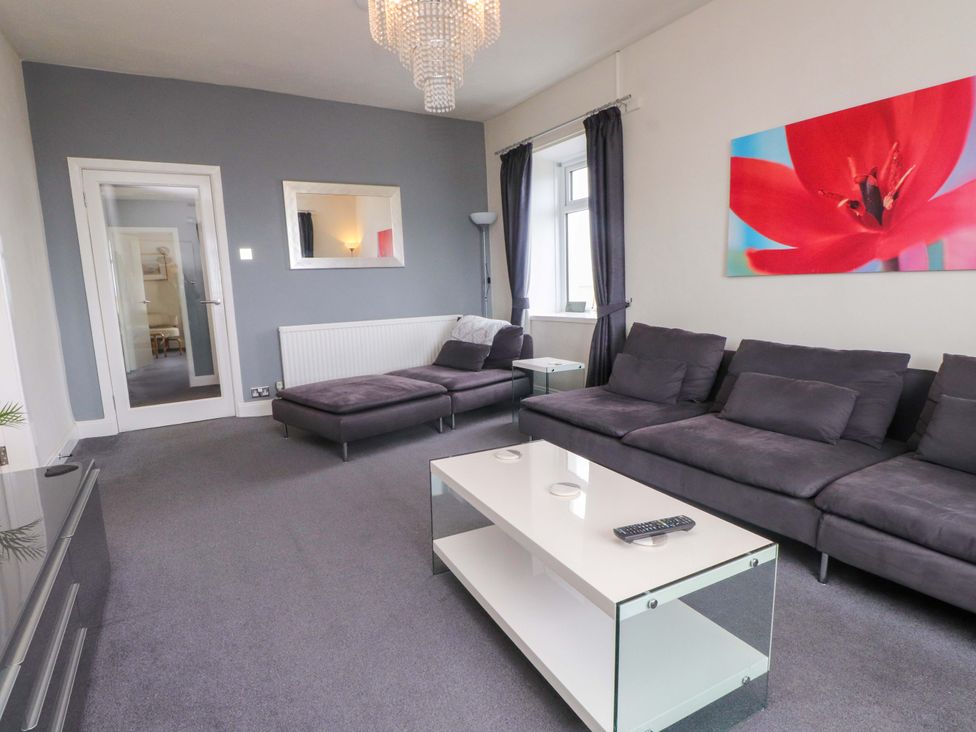 A living room with a sofa and coffee table at Sea Views No 8 Plas Darien in Trearddur Bay