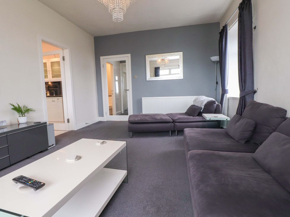 A living room with a sofa and coffee table at Sea Views No 8 Plas Darien Trearddur Bay