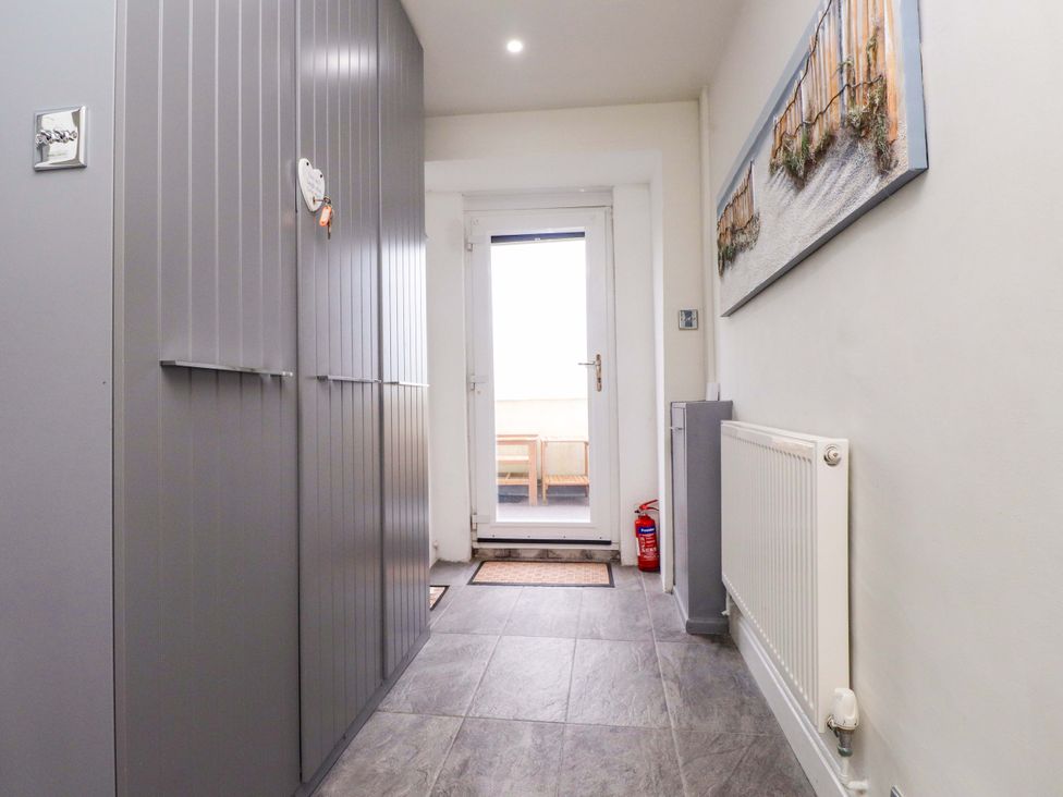 A hallway with storage cabinets and a door leading outside at Sea Views No 8 Plas Darien Trearddur Bay