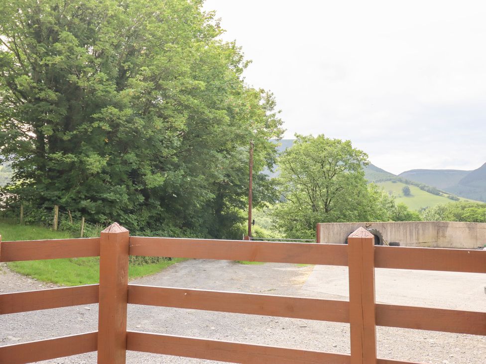 An outdoor scene with trees and a fence at Gwernffridd