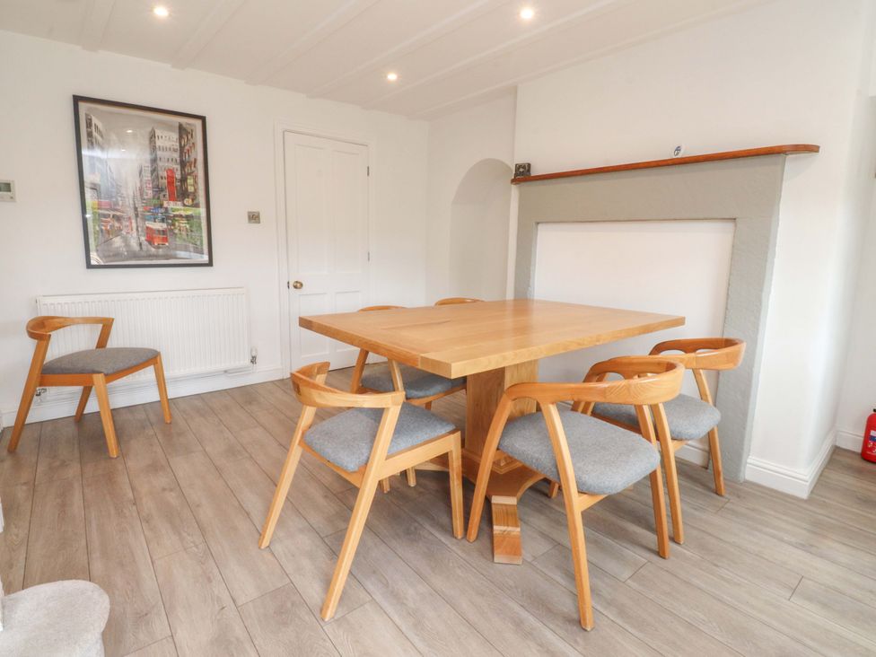 A dining room with a table and chairs at Rose Tree Cottage in Skipton