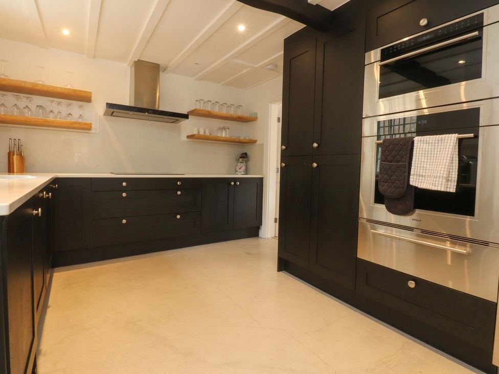 A kitchen with cabinets and an oven at Rose Tree Cottage in Skipton