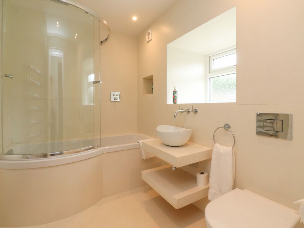 A bathroom with a shower, toilet, and sink at Rose Tree Cottage in Skipton