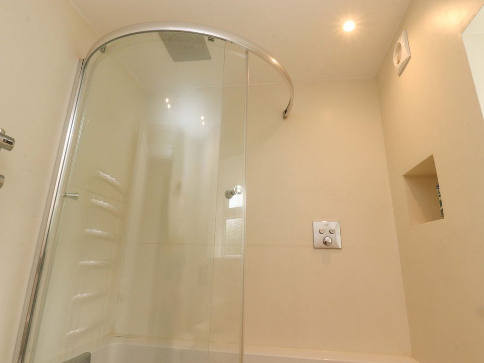 A bathroom with a shower enclosure and controls at Rose Tree Cottage in Skipton