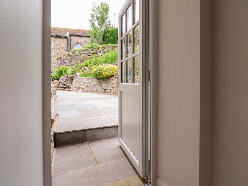 A view from a doorway to a garden area at Rose Tree Cottage in Skipton