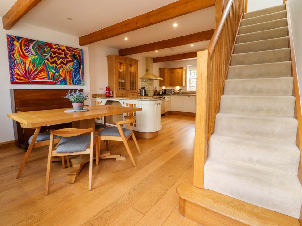 A dining room with a table and chairs at Rowan Tree Cottage in Skipsea