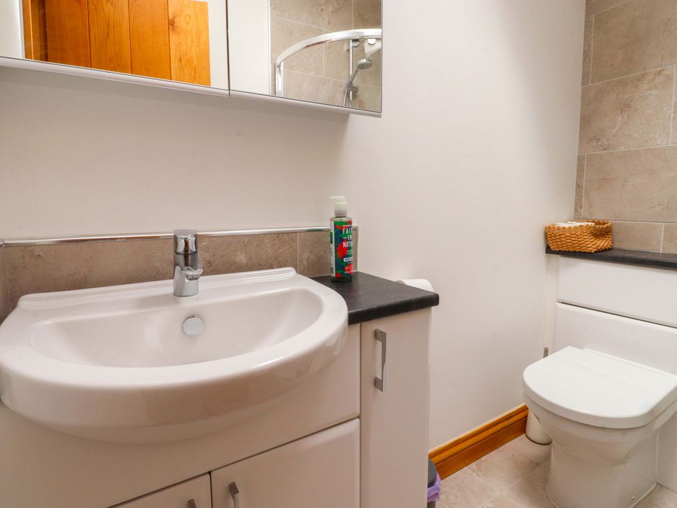 A bathroom with a sink and toilet at Rowan Tree Cottage in Skipsea