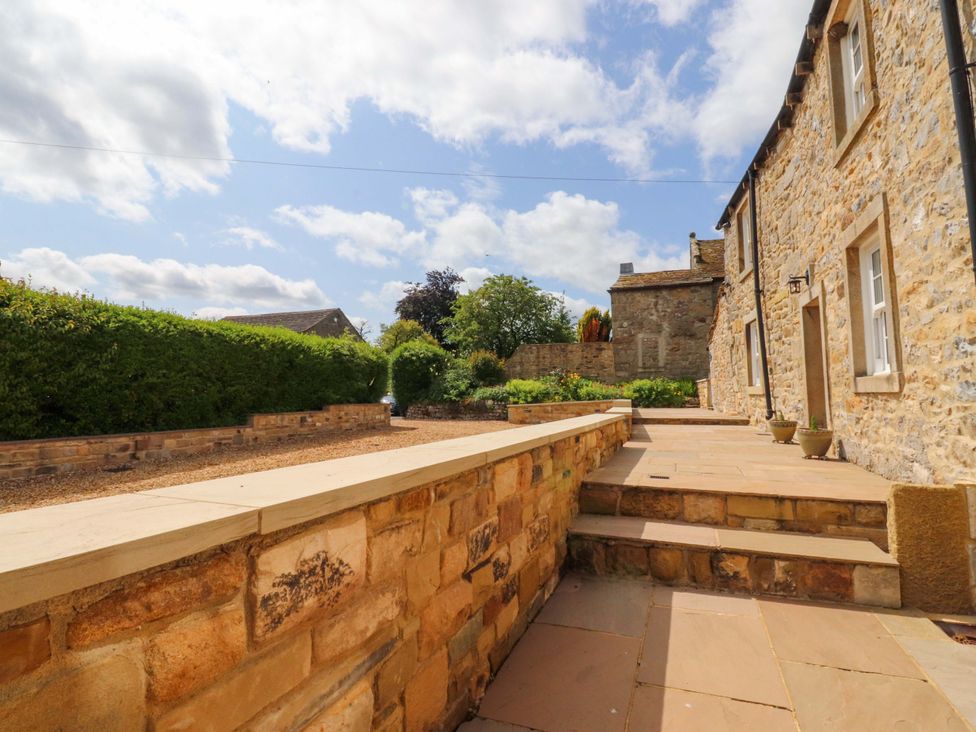 An outdoor area with stone walls and steps at Rowan Tree Cottage in Skipsea