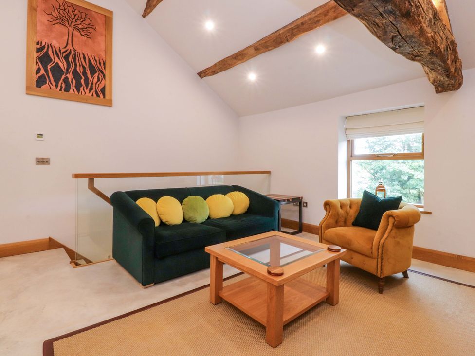 A living room with a sofa and an armchair at Welly Bob Cottage in Airton