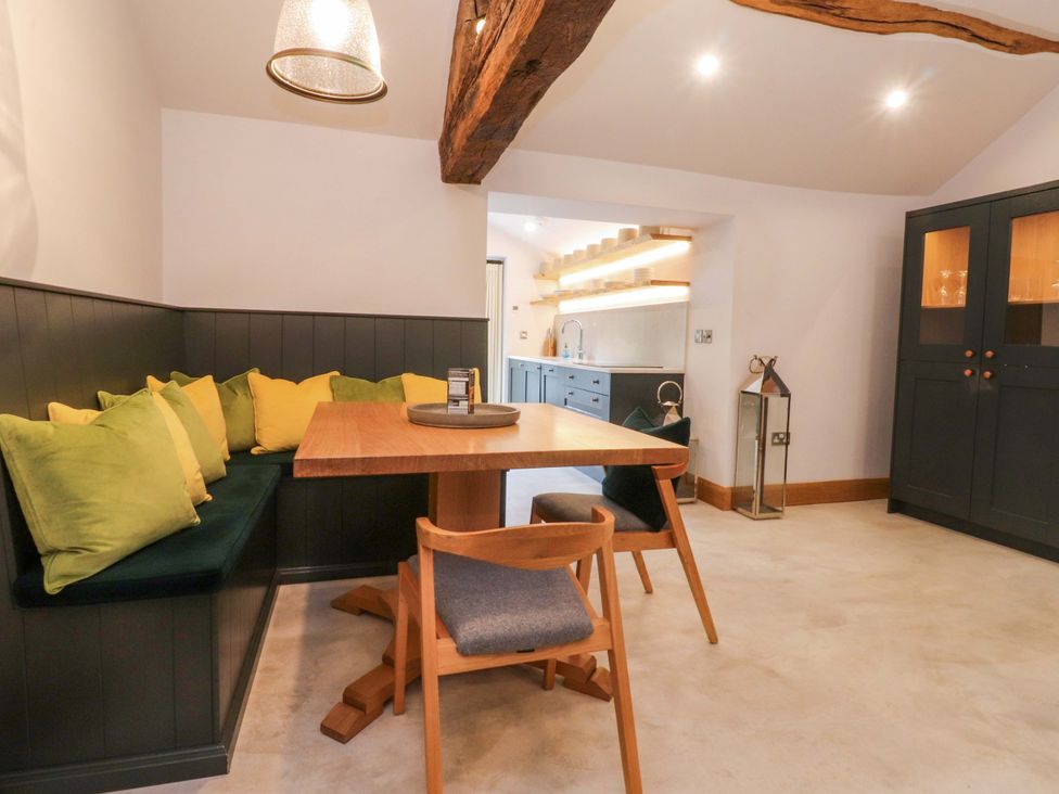 A dining area with a table and seating at Welly Bob Cottage in Airton