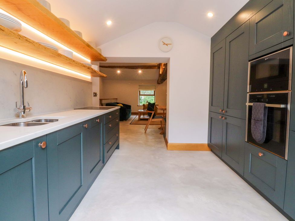 A kitchen with a sink and cabinets at Welly Bob Cottage in Airton