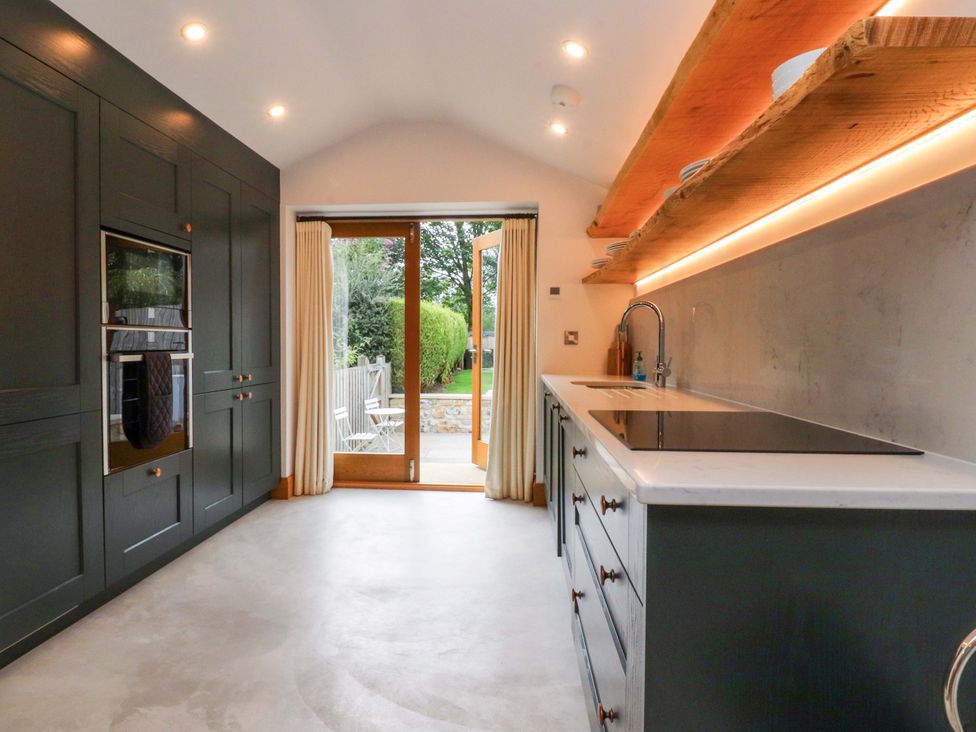 A kitchen with a sink and oven at Welly Bob Cottage Airton