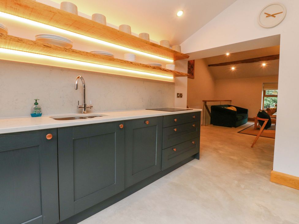 A kitchen with cabinets and a sink at Welly Bob Cottage Airton